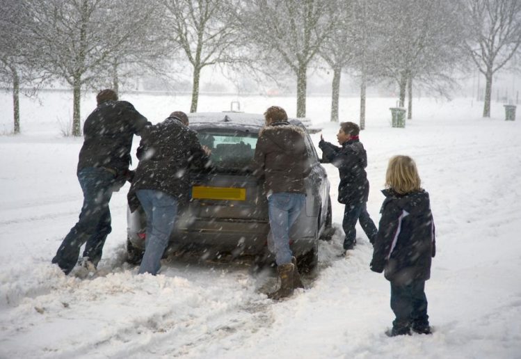 Car in disrepair requiring people to push it