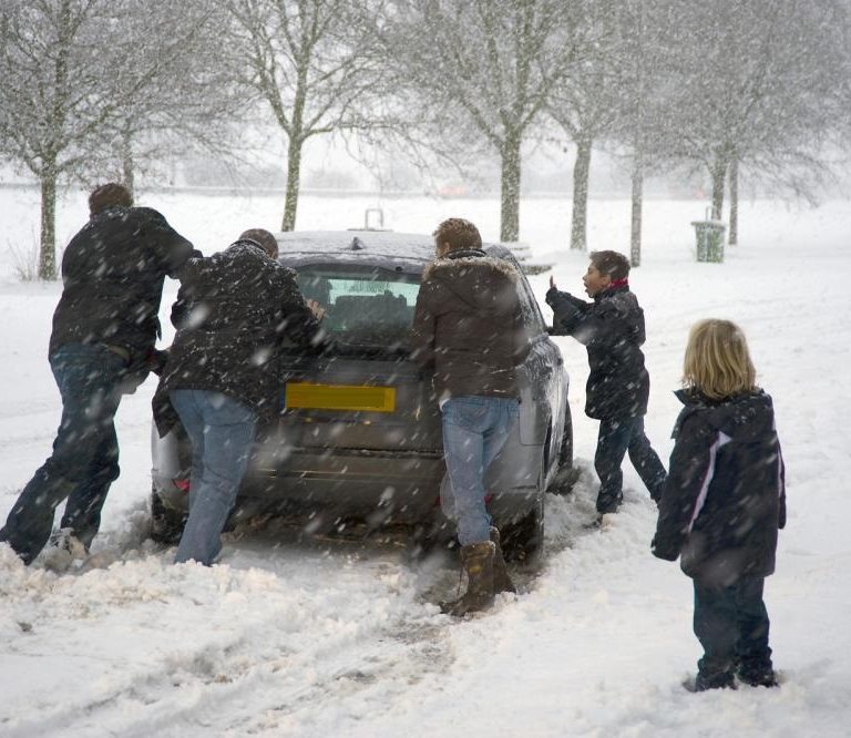 Car in disrepair requiring people to push it
