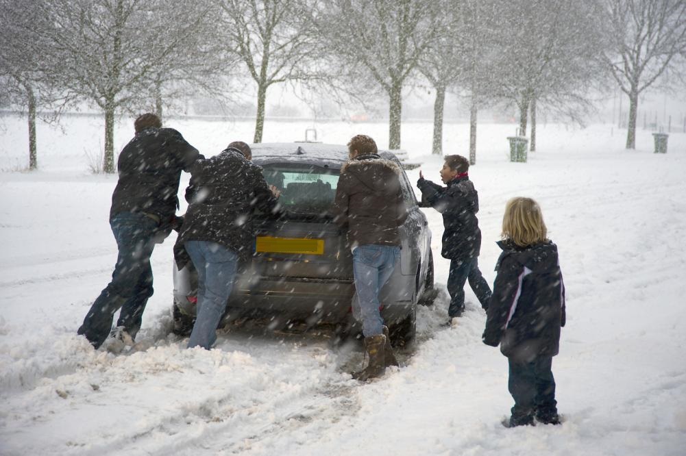 Car in disrepair requiring people to push it